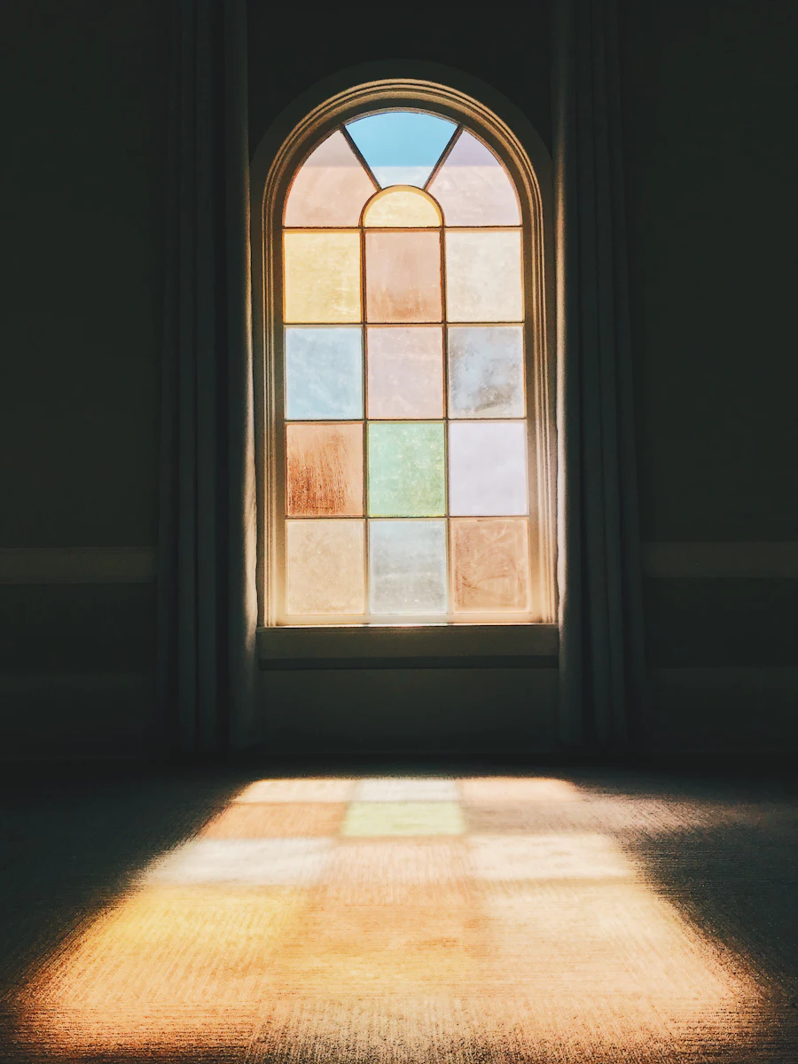 Light pouring through an arched church window