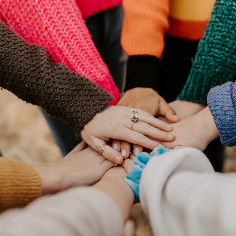Hands stacked together in a circle