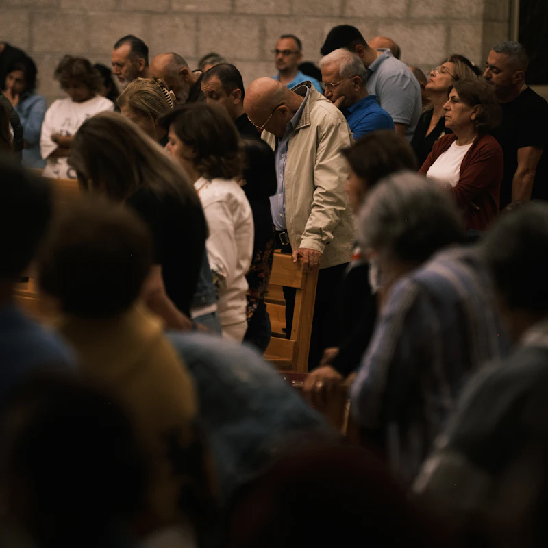 People with heads bowed in prayer