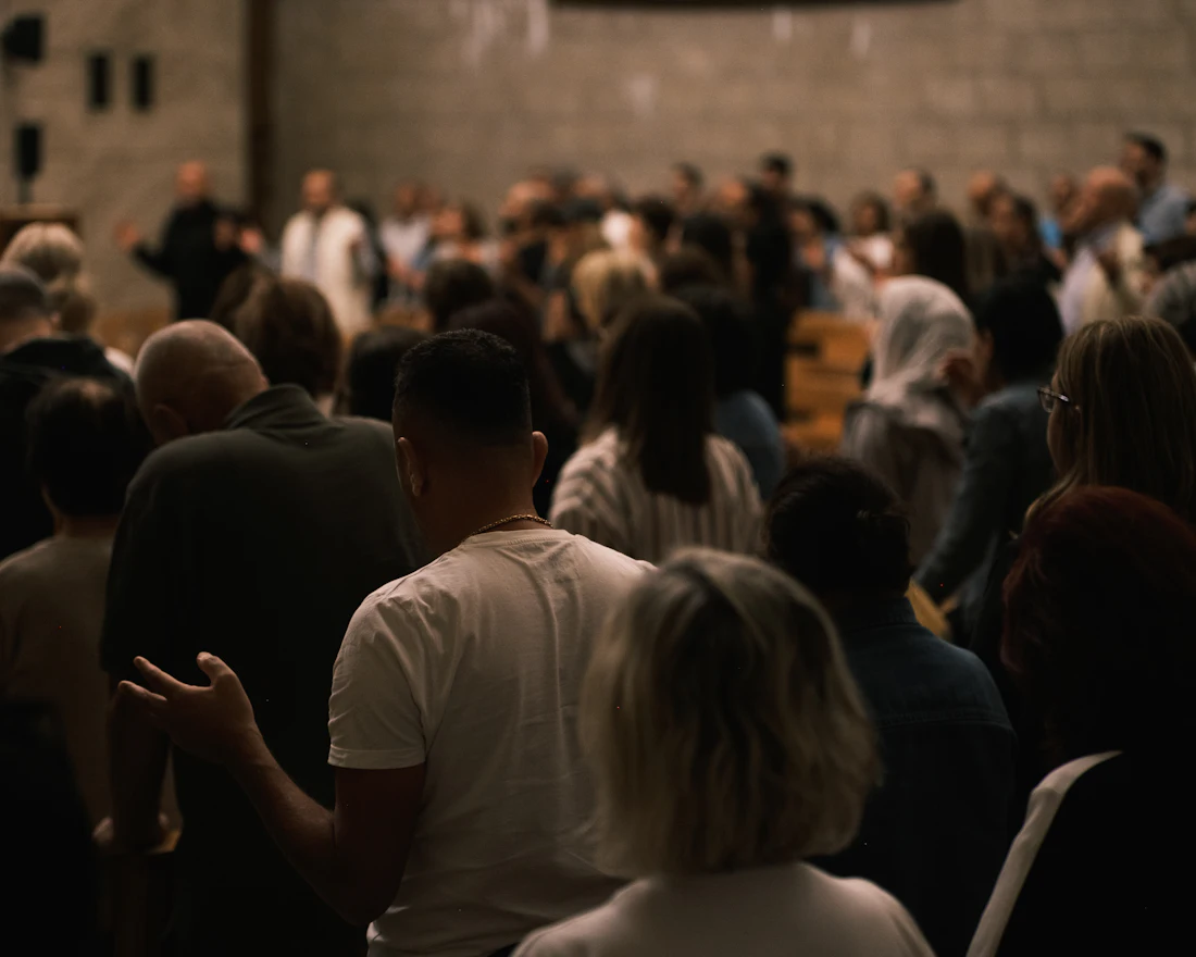 A congregation gathered inside a hall